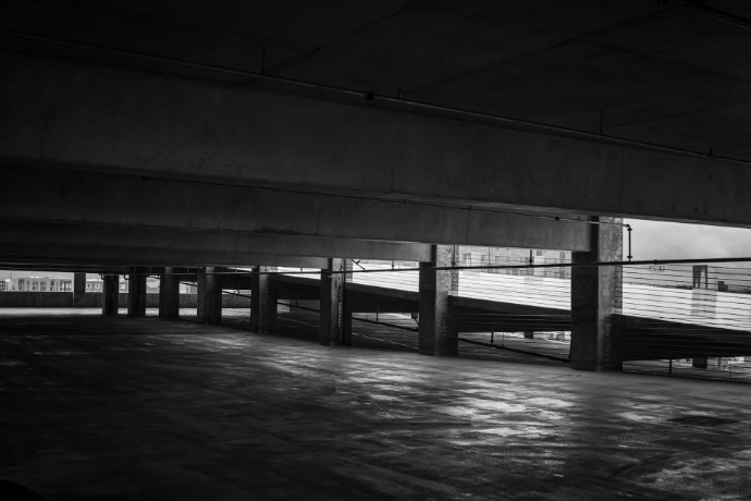 a black and white photo of a parking garage